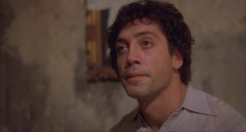 Movie still from “Before Night Falls” (2000), directed by Julian Schnabel – A person wearing a white shirt; Close Up shot, Low angle