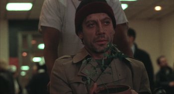 Movie still from “Before Night Falls” (2000), directed by Julian Schnabel – A man holding a plant in his hands; Close Up shot, Low angle