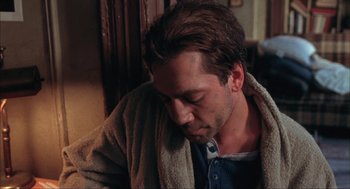 Movie still from “Before Night Falls” (2000), directed by Julian Schnabel – A person sitting down with his eyes closed; Close Up shot, High angle