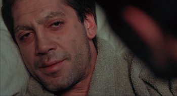 Movie still from “Before Night Falls” (2000), directed by Julian Schnabel – A man's face with a towel around his neck; Close Up shot, High angle