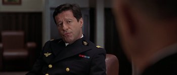 Movie still from “Behind Enemy Lines” (2001), directed by John Moore – A person wearing a military uniform; Close Up shot, Over the shoulder angle