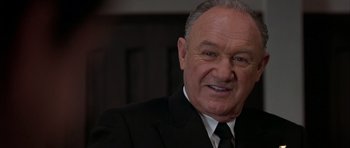 Movie still from “Behind Enemy Lines” (2001), directed by John Moore – An older man wearing a suit and tie; Close Up shot, Low angle