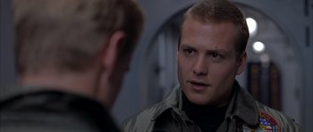 Movie still from “Behind Enemy Lines” (2001), directed by John Moore – A man looking into a mirror while standing next to another man; Close Up shot, Over the shoulder angle