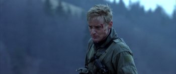 Movie still from “Behind Enemy Lines” (2001), directed by John Moore – A person with blood on his face; Close Up shot, Over the shoulder angle