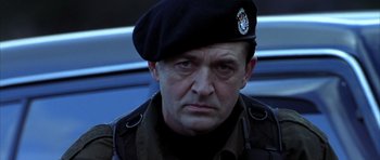 Movie still from “Behind Enemy Lines” (2001), directed by John Moore – A man in a military uniform wearing a hat; Close Up shot, Low angle