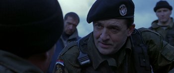 Movie still from “Behind Enemy Lines” (2001), directed by John Moore – A man in a military uniform looking at the camera; Close Up shot, Over the shoulder angle