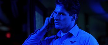 Movie still from “Behind Enemy Lines” (2001), directed by John Moore – A man talking on a cell phone in a dark room; Close Up shot, Low angle