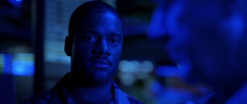 Movie still from “Behind Enemy Lines” (2001), directed by John Moore – A person wearing a blue shirt; Close Up shot, Low angle