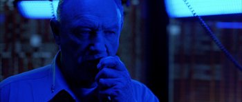 Movie still from “Behind Enemy Lines” (2001), directed by John Moore – An older man with his hand under his chin; Close Up shot, Low angle