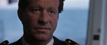 Movie still from “Behind Enemy Lines” (2001), directed by John Moore – A person wearing a military uniform; Close Up shot, Over the shoulder angle