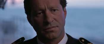 Movie still from “Behind Enemy Lines” (2001), directed by John Moore – A person wearing a suit and tie; Close Up shot, Low angle