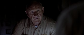 Movie still from “Behind Enemy Lines” (2001), directed by John Moore – An older man in a uniform looking at the camera; Close Up shot, Over the shoulder angle