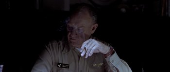 Movie still from “Behind Enemy Lines” (2001), directed by John Moore – An older man smoking a cigarette while wearing an army uniform; Close Up shot, Low angle