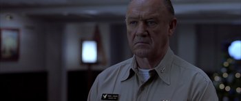 Movie still from “Behind Enemy Lines” (2001), directed by John Moore – An older man in a military uniform stares at the camera; Close Up shot, Low angle