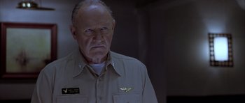 Movie still from “Behind Enemy Lines” (2001), directed by John Moore – An older man wearing a uniform with a pilot's badge on his chest; Close Up shot, Low angle