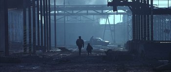 Movie still from “Behind Enemy Lines” (2001), directed by John Moore – A man and a child walking in the fog; Extreme Wide shot, Low angle