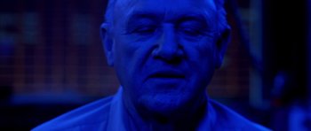 Movie still from “Behind Enemy Lines” (2001), directed by John Moore – An old man with blue light on his face; Close Up shot, Overhead angle