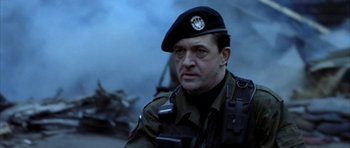 Movie still from “Behind Enemy Lines” (2001), directed by John Moore – A man in a military uniform wearing a hat; Close Up shot, Low angle
