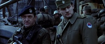 Movie still from “Behind Enemy Lines” (2001), directed by John Moore – A group of men standing next to each other; Medium shot, Low angle