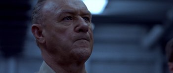 Movie still from “Behind Enemy Lines” (2001), directed by John Moore – An older man looking into the distance with a serious look; Close Up shot, Low angle