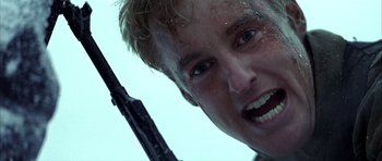 Movie still from “Behind Enemy Lines” (2001), directed by John Moore – A person holding a gun; Close Up shot, Low angle