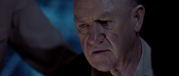 Movie still from “Behind Enemy Lines” (2001), directed by John Moore – An older man with a sad look on his face; Close Up shot, Low angle
