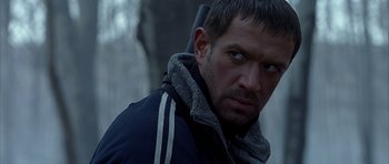 Movie still from “Behind Enemy Lines” (2001), directed by John Moore – A person wearing a jacket; Close Up shot, Over the shoulder angle