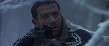 Movie still from “Behind Enemy Lines” (2001), directed by John Moore – A person holding a gun; Close Up shot, Low angle
