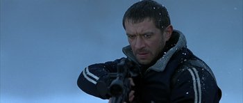 Movie still from “Behind Enemy Lines” (2001), directed by John Moore – A person holding a gun; Close Up shot, Low angle