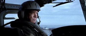 Movie still from “Behind Enemy Lines” (2001), directed by John Moore – A man in a helmet is in a helicopter; Close Up shot, Low angle