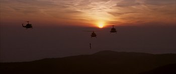 Movie still from “Behind Enemy Lines” (2001), directed by John Moore – Two helicopters flying in the air at sunset; Extreme Wide shot, Low angle