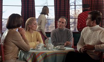 Movie still from “Belle de Jour” (1967), directed by Luis Buñuel – A group of people sitting at a table with cups of coffee; Medium shot, Over the shoulder angle