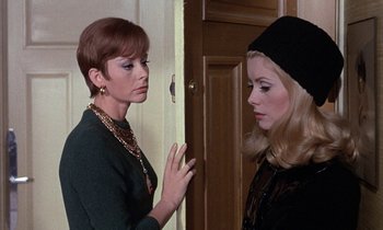 Movie still from “Belle de Jour” (1967), directed by Luis Buñuel – Two women standing next to each other near a door; Close Up shot, Over the shoulder angle