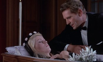 Movie still from “Belle de Jour” (1967), directed by Luis Buñuel – A man and a woman dressed in formal wear; Medium shot, Over the shoulder angle