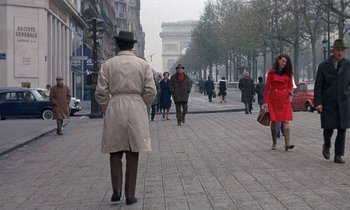 Movie still from “Belle de Jour” (1967), directed by Luis Buñuel – A group of people walking down a street; Wide shot, Over the shoulder angle