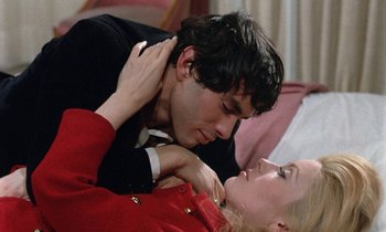Movie still from “Belle de Jour” (1967), directed by Luis Buñuel – A man and a woman laying on a bed; Close Up shot, Overhead angle