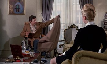 Movie still from “Belle de Jour” (1967), directed by Luis Buñuel – A man and a woman sitting in a living room; Medium shot, Over the shoulder angle