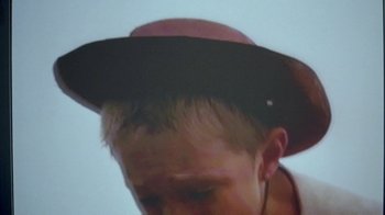 Movie still from “Belly” (1998), directed by Hype Williams – A man wearing a hat with a small hole in it's brim; Extreme Close Up shot, Low angle