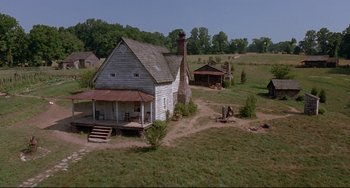 Movie still from “Beloved” (1998), directed by Jonathan Demme – An old farm house in the middle of a field; Extreme Wide shot, High angle