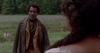 Movie still from “Beloved” (1998), directed by Jonathan Demme – A man and a woman are standing in a field; Medium shot, Over the shoulder angle