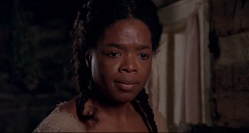 Movie still from “Beloved” (1998), directed by Jonathan Demme – A person with long braids; Close Up shot, Over the shoulder angle