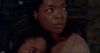 Movie still from “Beloved” (1998), directed by Jonathan Demme – A woman and a child are looking at the camera; Close Up shot, Over the shoulder angle