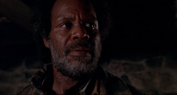 Movie still from “Beloved” (1998), directed by Jonathan Demme – An older man with a beard and a mustache; Close Up shot, Low angle