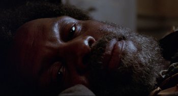 Movie still from “Beloved” (1998), directed by Jonathan Demme – A man with a beard; Close Up shot, Overhead angle