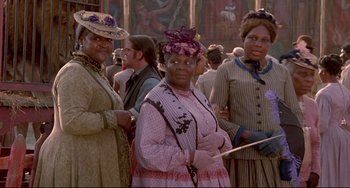 Movie still from “Beloved” (1998), directed by Jonathan Demme – A group of women standing next to each other; Medium shot, Low angle