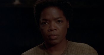 Movie still from “Beloved” (1998), directed by Jonathan Demme – A person with short black hair; Close Up shot, High angle