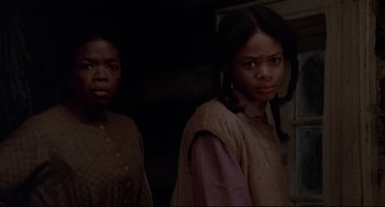 Movie still from “Beloved” (1998), directed by Jonathan Demme – Two young women standing next to each other in front of a wall; Close Up shot, Over the shoulder angle