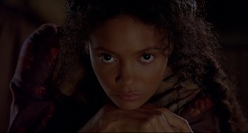 Movie still from “Beloved” (1998), directed by Jonathan Demme – A young woman is looking into the camera; Close Up shot, High angle