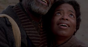 Movie still from “Beloved” (1998), directed by Jonathan Demme – An older man and a younger man looking up at the sky; Close Up shot, Low angle