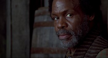 Movie still from “Beloved” (1998), directed by Jonathan Demme – A person with a beard; Close Up shot, Low angle